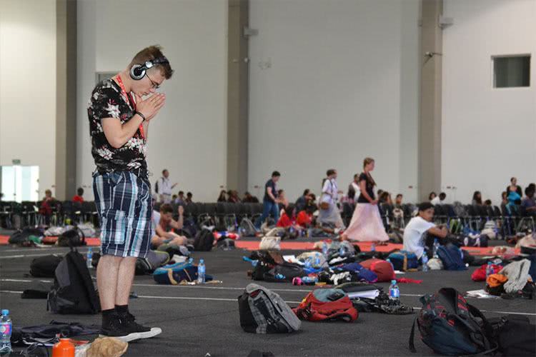 A pilgrim prays in the main hall at the Paradise in the City festival in Ã…ÂÃƒÂ³dÃ…Âº. Photo: WYM